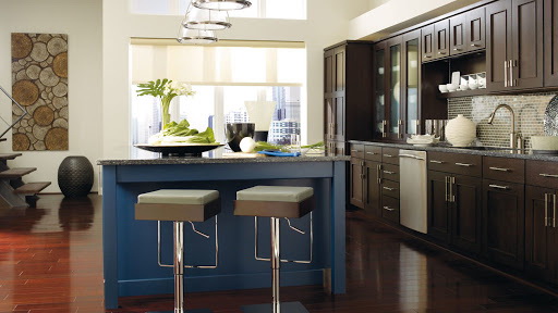 DARK WOOD CABINETS WITH A BLUE KITCHEN ISLAND